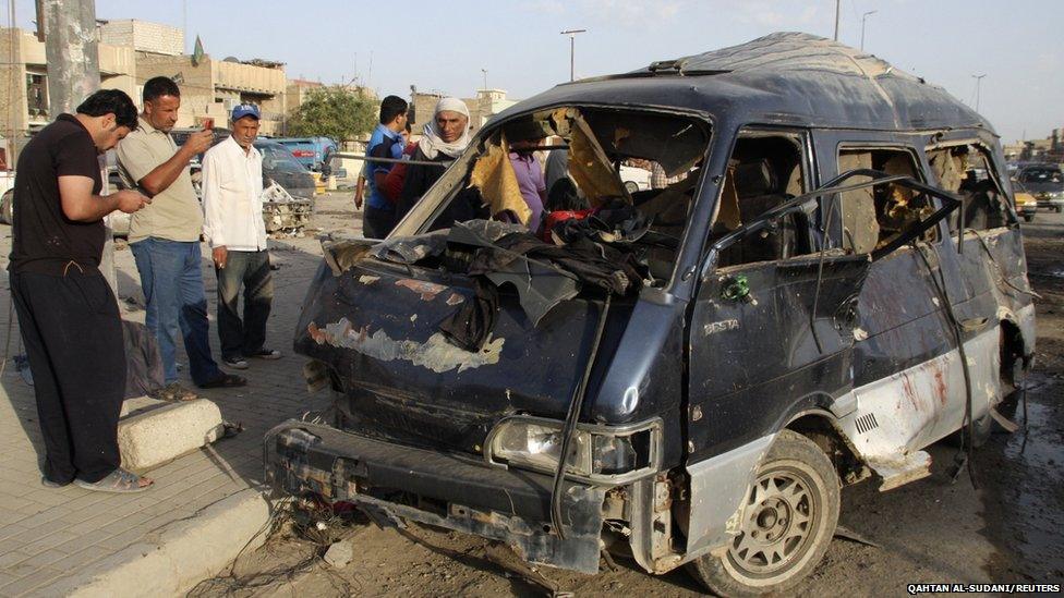 Residents gather at the site of a car bomb attack in Baghdad's Sadr City (16 May 2013)