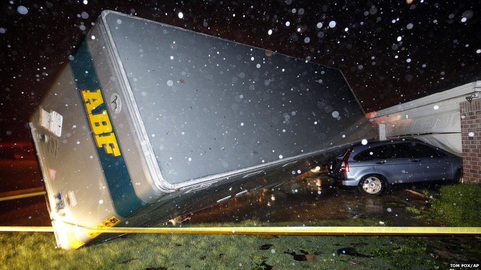 A trailer landed on a car that was parked in front of a home in Cleburne, Texas after a powerful storm went through (15 May 2013)