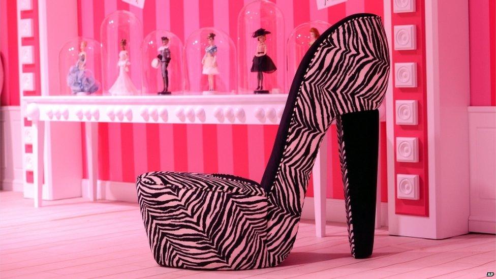 Chair shaped like a high-heel is is displayed in the Barbie Dreamhouse Experience near Alexanderplatz square in Berlin, 16 May, 2013.