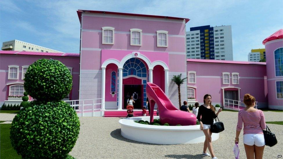 Visitors stand in front of the Berlin Barbie Dreamhouse Experience, 16 May 2013