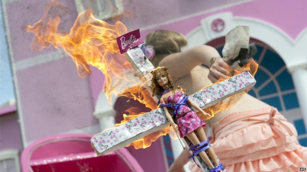 A topless Femen activist at the Barbie Dreamhouse in Berlin, 16 May 2013