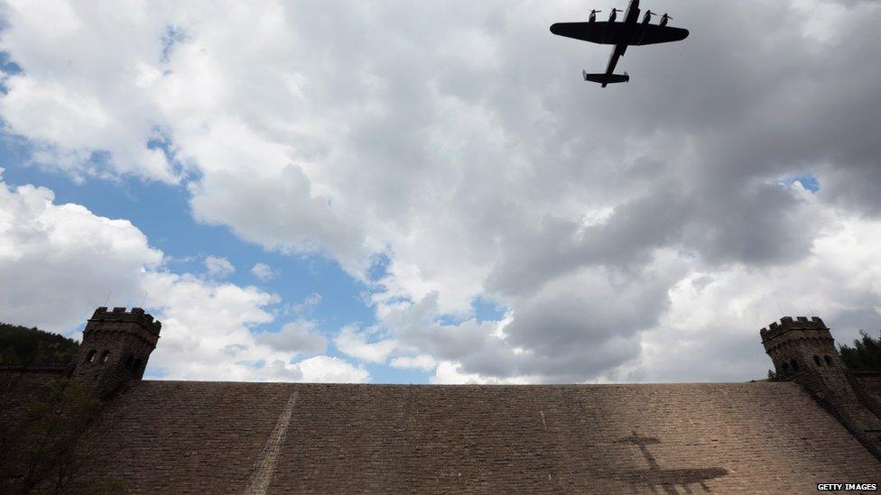 Lancaster bomber flying over dam