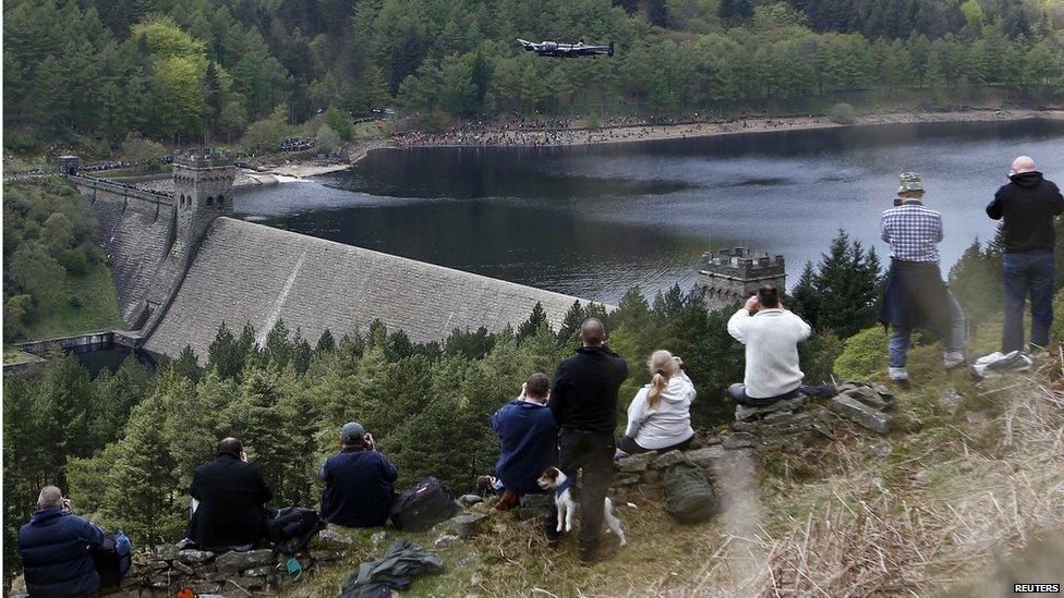 photographers on dam bank