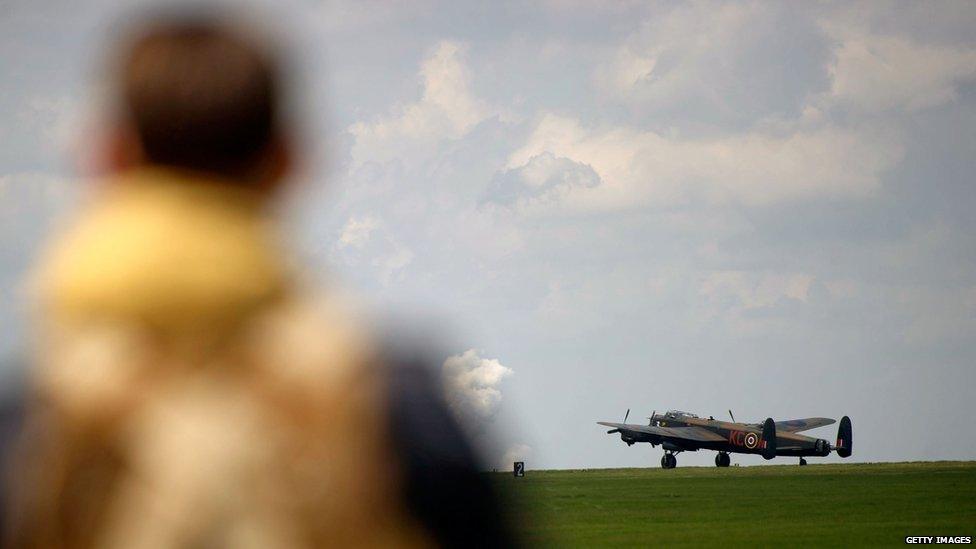 Man watching Lancaster bomber take-off