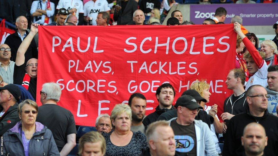 Fans hold up a banner for Paul Scholes