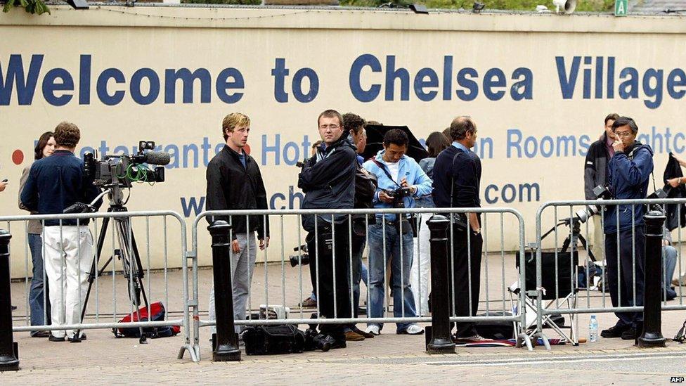 The media wait in front of Chelsea Football Club in London on 2 July, 2003.