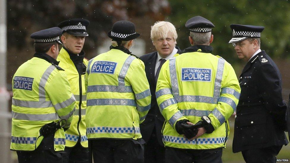 Boris Johnson speaks to police officers near the scene of the attack