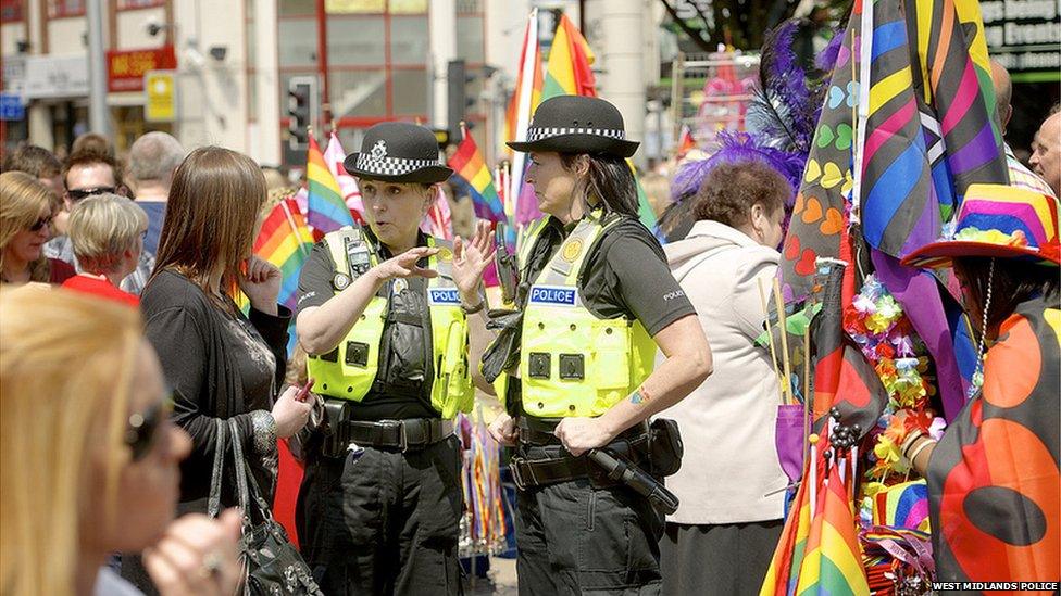 Police officers talking to festivalgoers