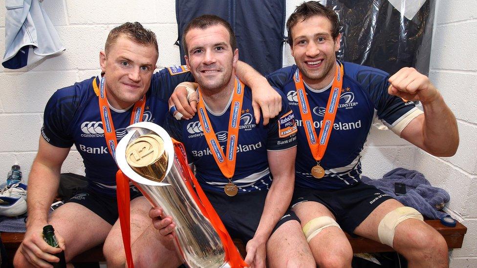 Jamie Heaslip, Shane Jennings and Kevin McLaughlin with the Pro12 trophy in the Leinster dressing room