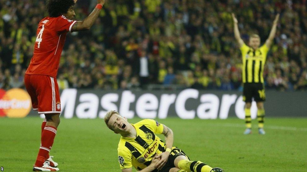 Dante fouls Marco Reus for the penalty from which Dortmund equalise