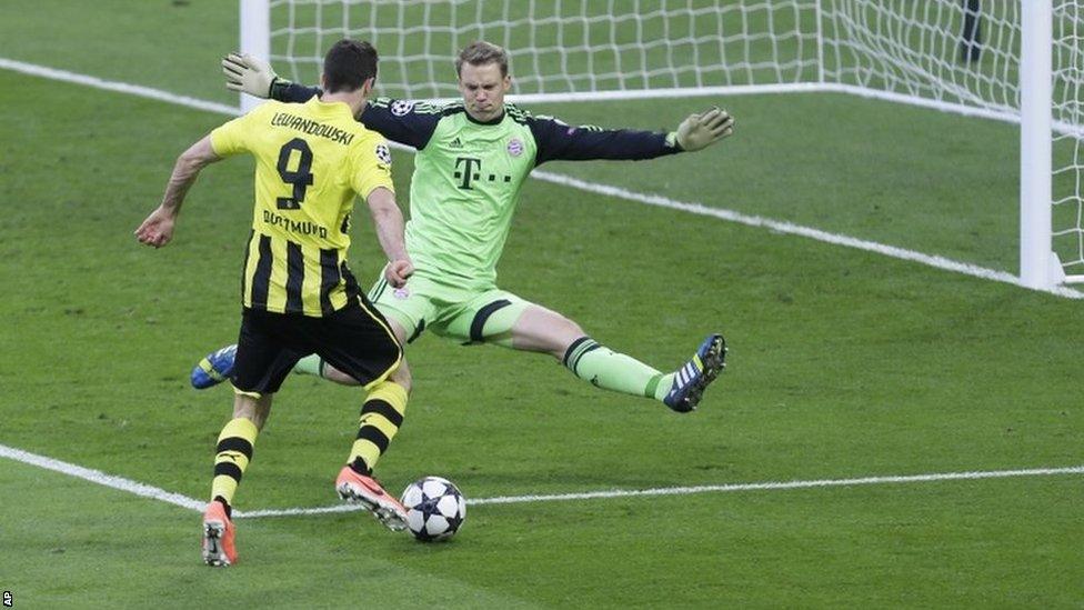 Bayern goalkeeper Manuel Neuer blocks a shot by Dortmund's Robert Lewandowski