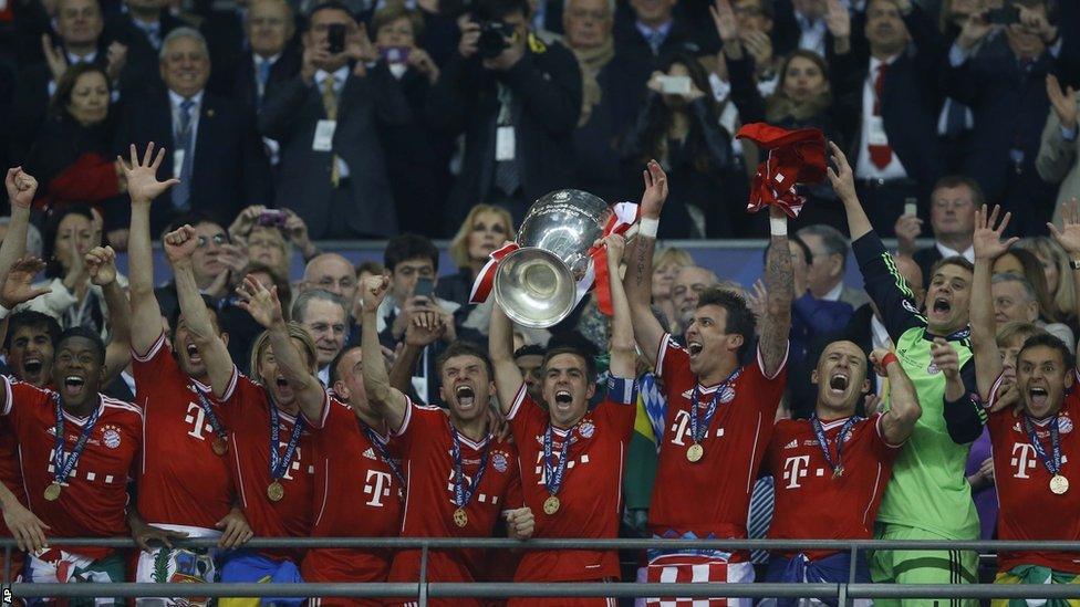 Philipp Lahm of Bayern Munich lifts the Champions League trophy