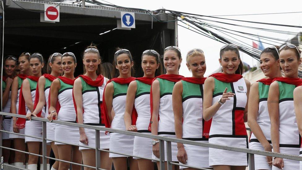 Pit girls line up during the qualifying session of the Monaco