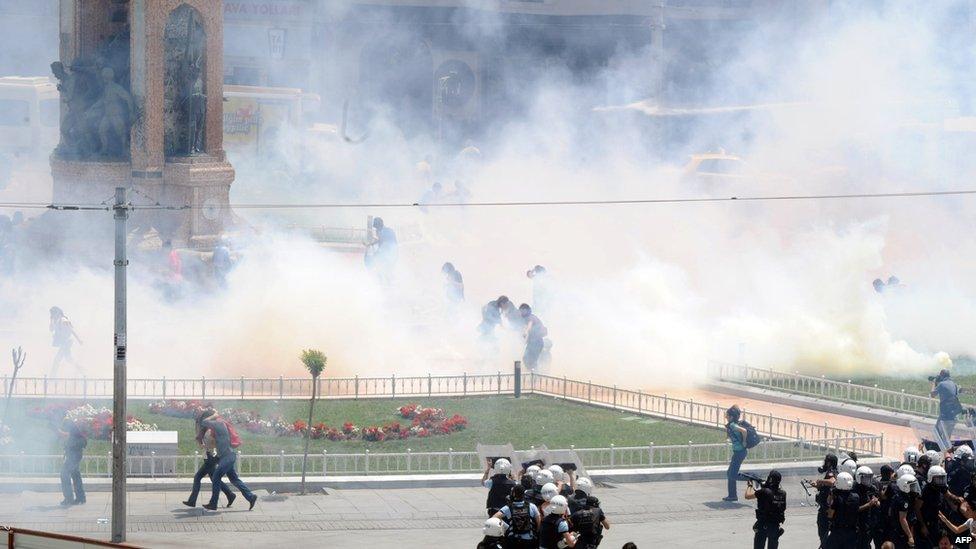 Turkish riot policemen use tear gas to disperse people protesting against the demolition of Taksim Gezi Park, in Taksim Square, Istanbul, 31 May 2013