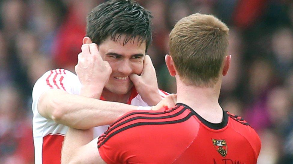 Derry defender Chrissy McKaigue and Mourne forward Benny Coulter get to grips with each other early in the game