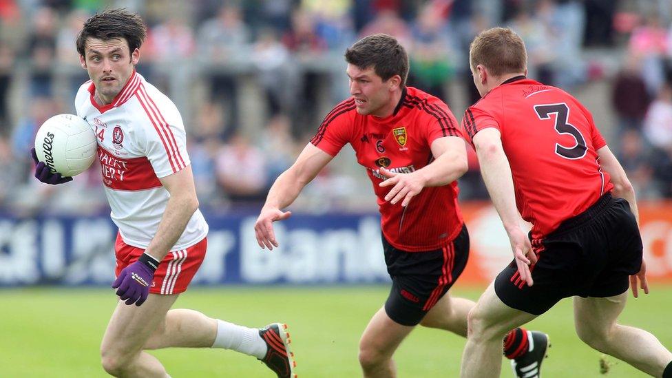 Derry forward Eoin Bradley moves clear of Peter Turley and Brendan McArdle