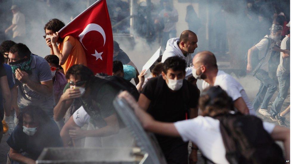 Young Turks are hit by tear gas in Ankara on 2 June.