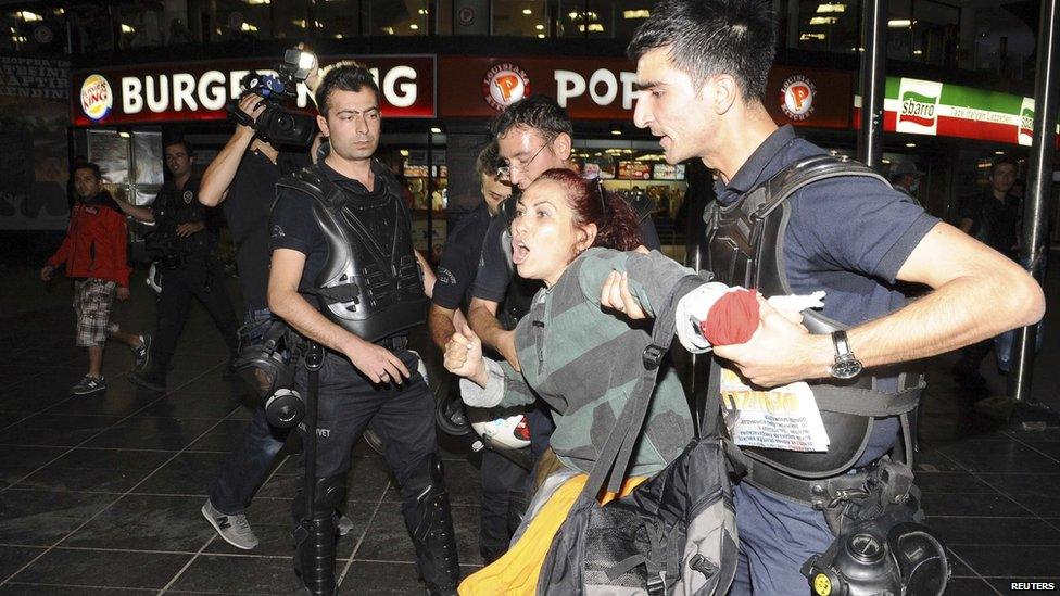 Riot police detain a female protester in Ankara, 2 June.