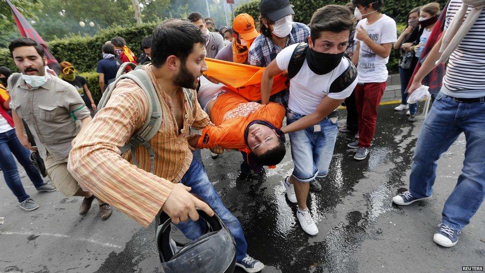 Protesters carry an injured man in central Ankara, 2 June.