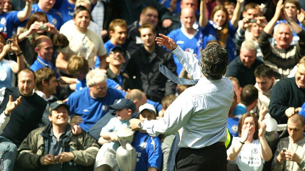 Jose Mourinho throws his winner's medal into the crowd