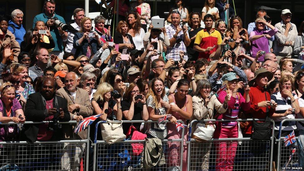 Crowds stand outside a service