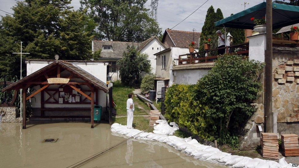 Locals chat in flooded Kisoroszi, north of Budapest, Hungary, 7 June 2013