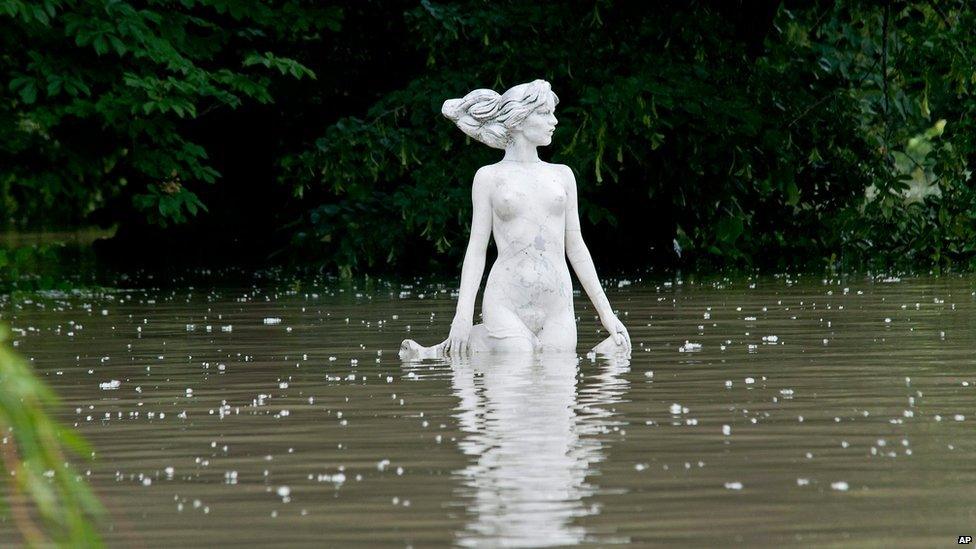 A statue is seen in the floodwater of the Moson branch of Danube in Gyor, 120 kms west of Budapest, Hungary, 6 June 2013