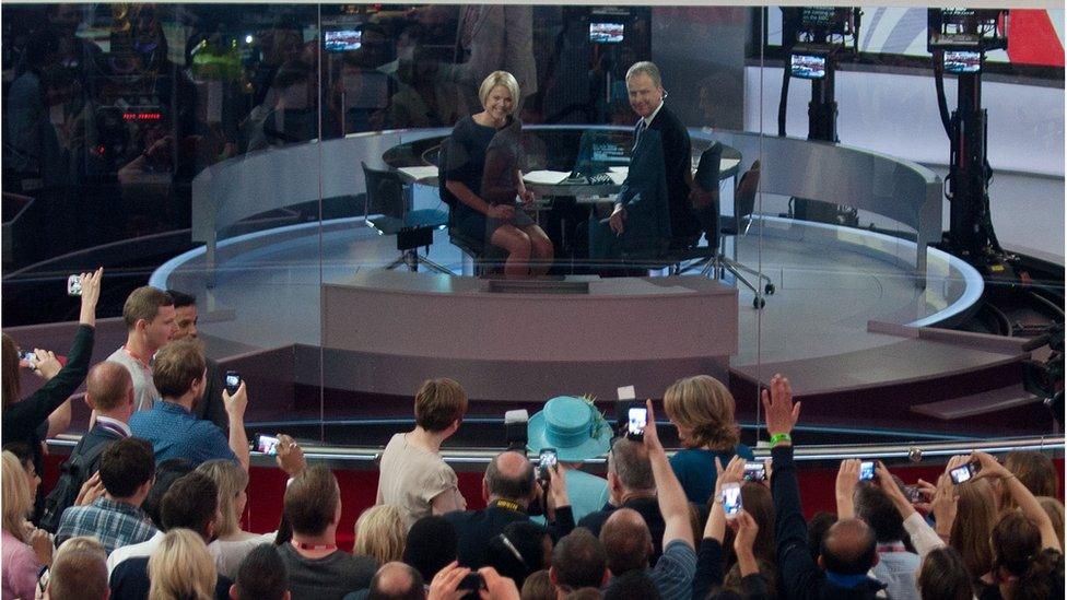 The Queen appears on the BBC News Channel behind the newsreaders