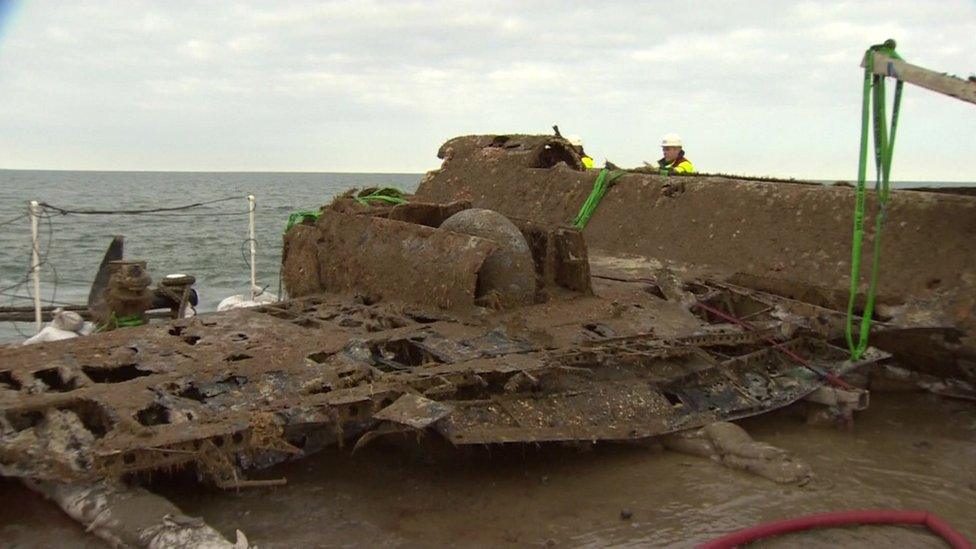 The wreckage of the Second World War German Dornier Do-17 bomber on a salvage barge