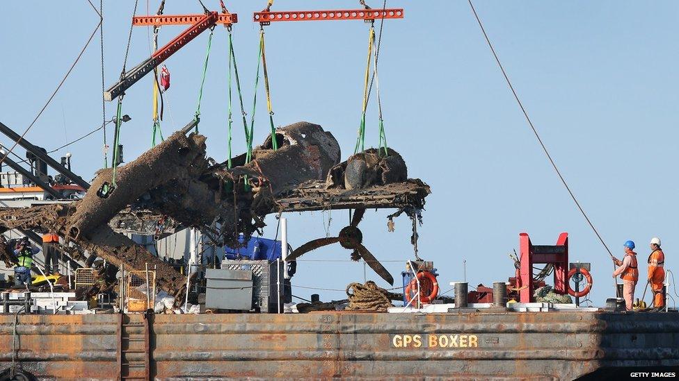 Dornier bomber wreckage being lifted on to barge