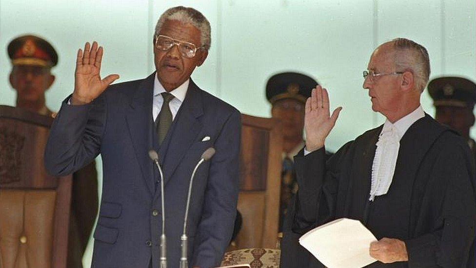 Nelson Mandela takes his presidential oath of office in 1994