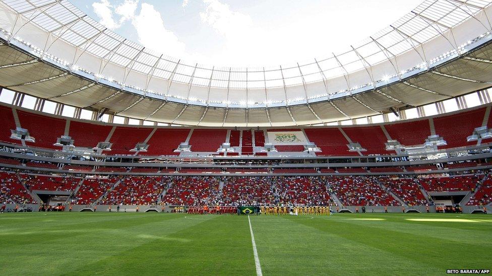 Players stand on the field at the Mane Garrincha National Stadium before the 2013 Brasilia's Championship final football match between Brasilia and Brasiliense in Brasilia, 18 May 2013