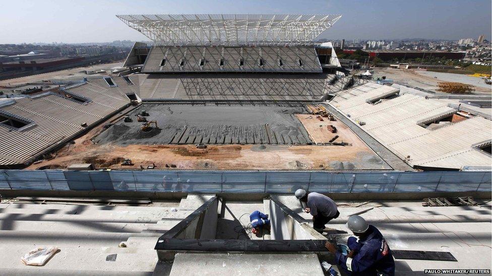 Employees work on the site of the Arena Sao Paulo stadium in Sao Paulo