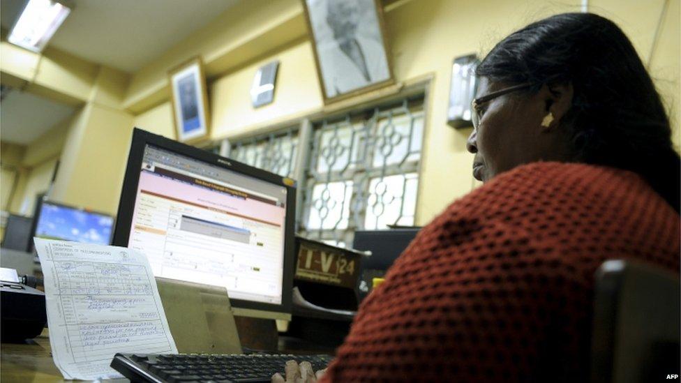 An employee feeds in a telegram message onto a computer to be sent via telegraph at a telecommunications office in Bangalore