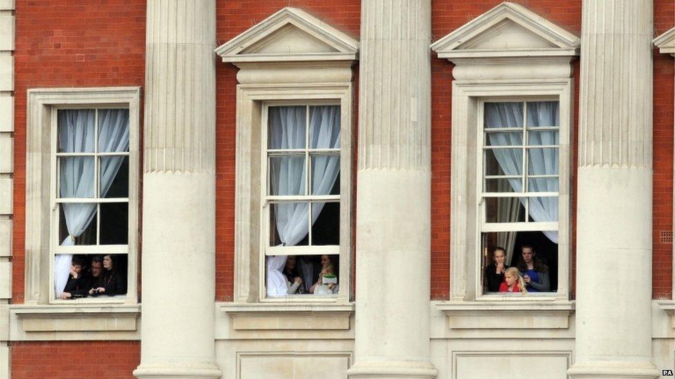 Members of the public watch from windows during Trooping the Colour, in Horse Guards Parade, London