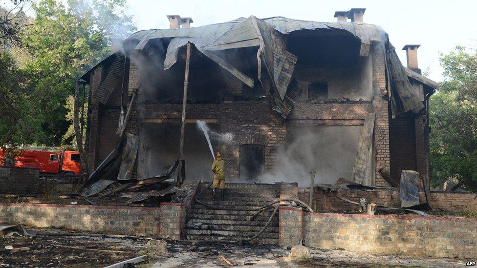 A Pakistani firefighter extinguishes a fire which gutted a historical building in Ziarat, south-east of Quetta, 15 June