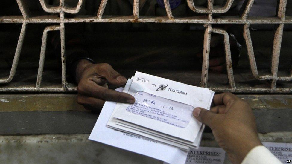 An Indian staff member, foreground, of central telegraph office dispatches telegrams in Mumbai, India, Friday, June 14, 2013