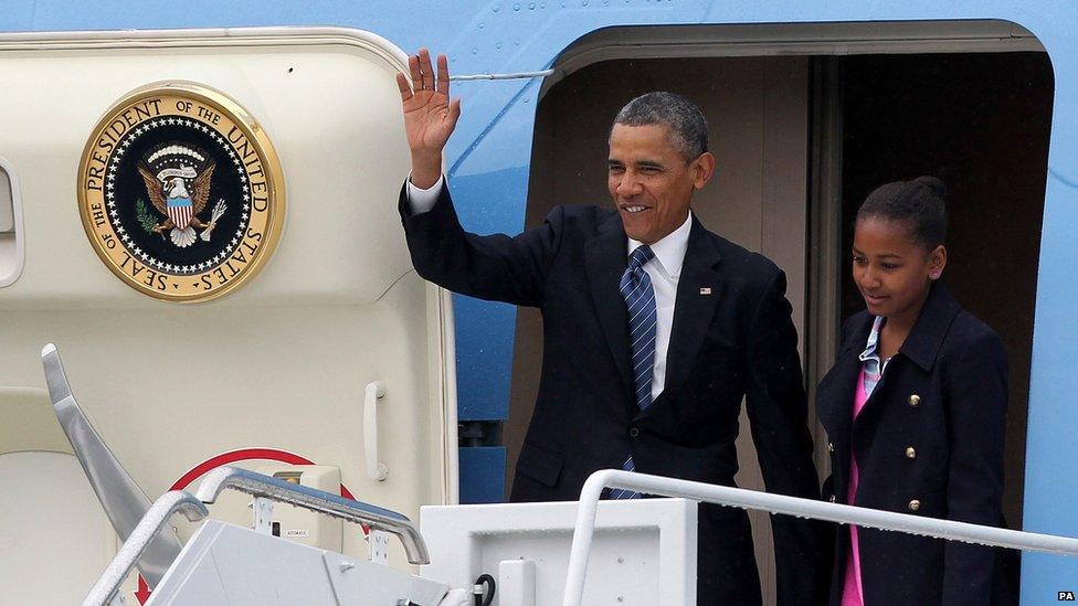 US President Barack Obama waves as he leaves his plane with daughter Sasha.