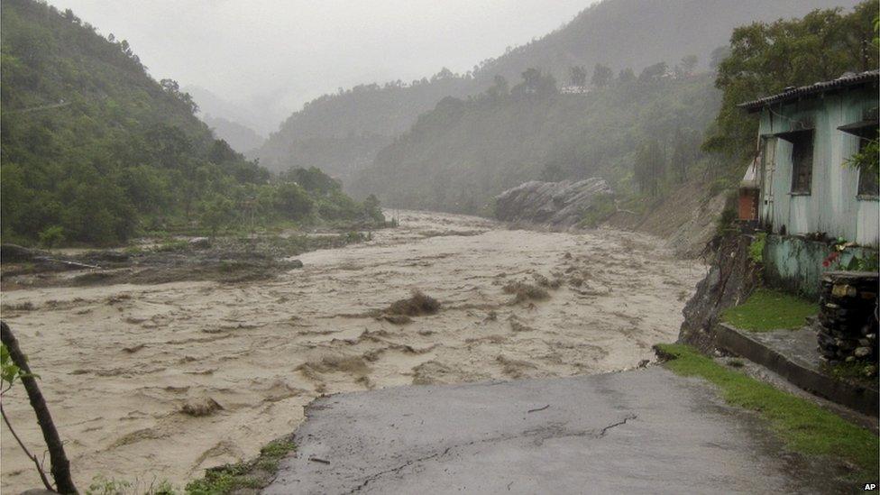 A flooded Badrinath highway road is seen near Joshimath district in northern Indian state of Uttarakhand, India, Monday, June 17, 2013