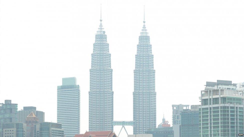 Haze cover Malaysia's landmark Petronas Twin Towers in Kuala Lumpur on 17 June 2013