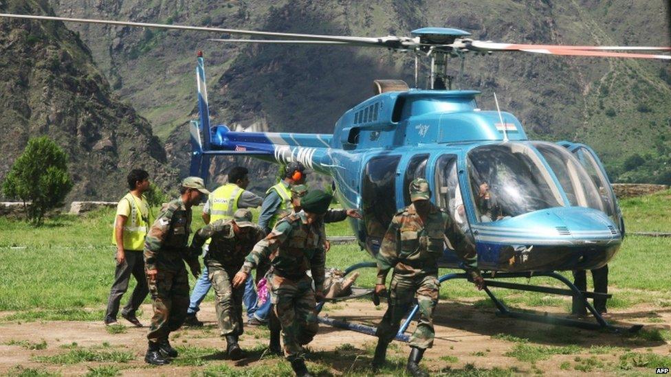 Members of the Indian Army evacuate an injured person during a search and rescue operation in the Chamoli district in the northern Uttarakhand state on June 19, 2013.