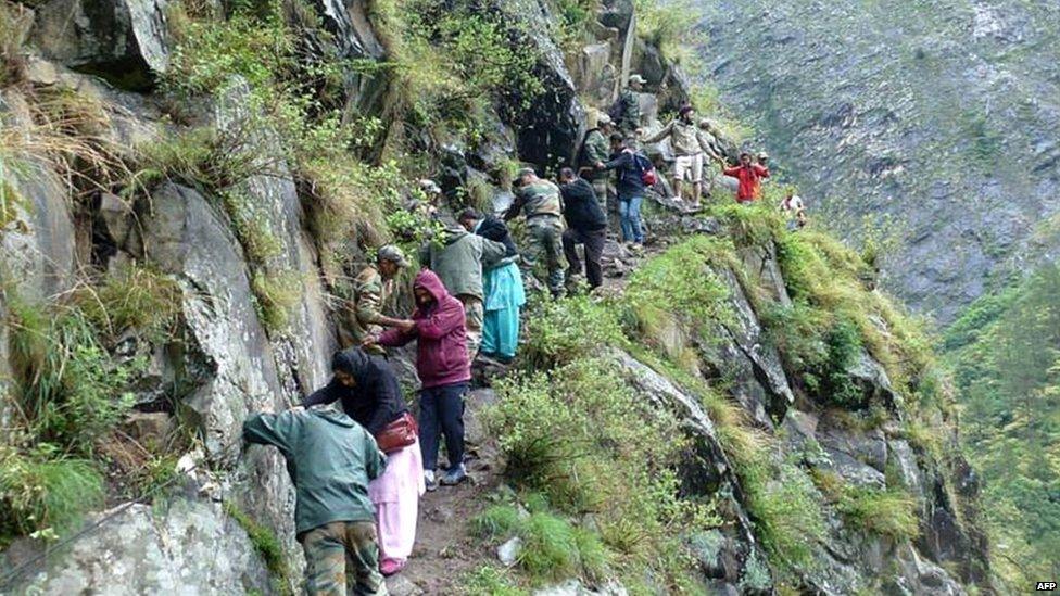 In this photograph received from the Defence Ministry on June 19, 2013 members of the Indian Defence Forces rescue stranded villagers in the northern Uttarakhand state.