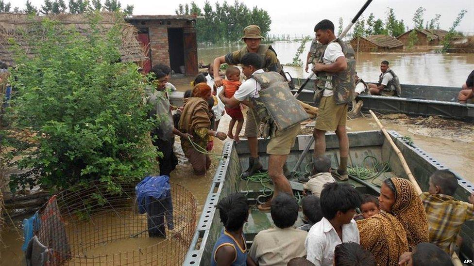 In this photograph received from the Defence Ministry on June 19, 2013 members of the Indian Defence Forces rescue stranded villagers in the northern Uttarakhand state