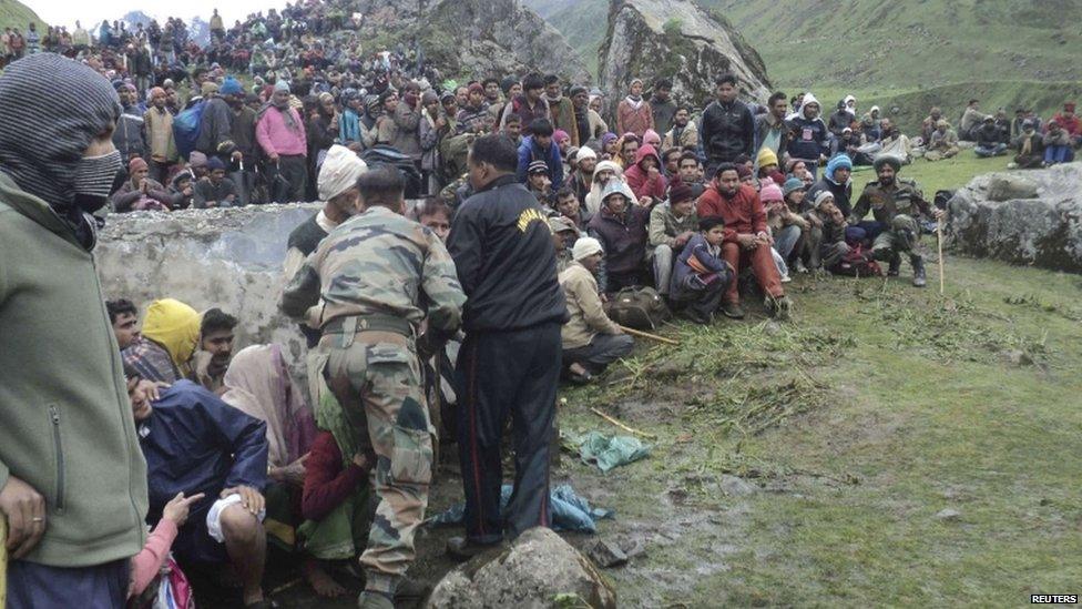 Members of the Indian Army gather stranded tourists and villagers who were rescued in the Himalayan state of Uttarakhand June 18, 2013