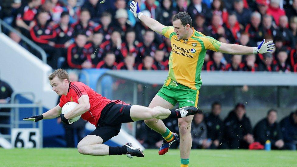 Brendan McArdle of Down hits the deck as Donegal forward Michael Murphy moves in at Breffni Park