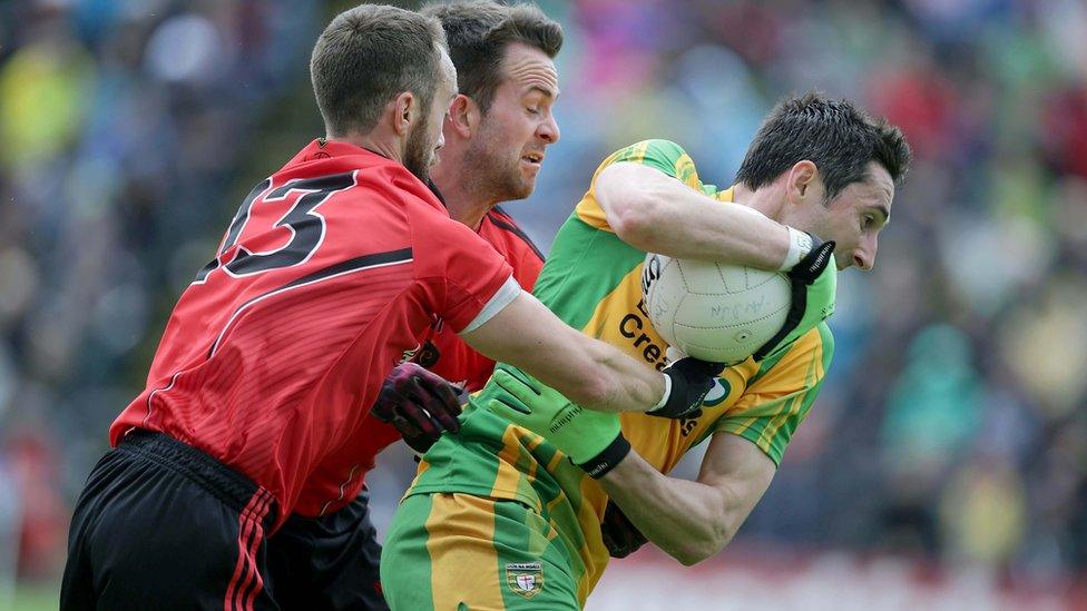 Conor Laverty and Mark Poland of Down attempt to halt the progress of Donegal's Rory Kavanagh