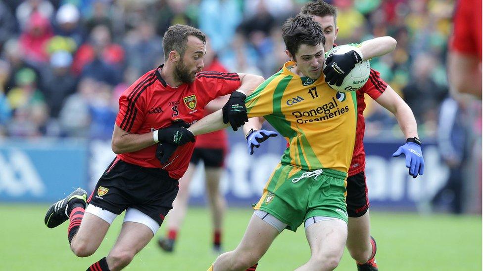 Conor Laverty and Ryan Boyle of Down combine to check an attack by Donegal's Ryan McHugh