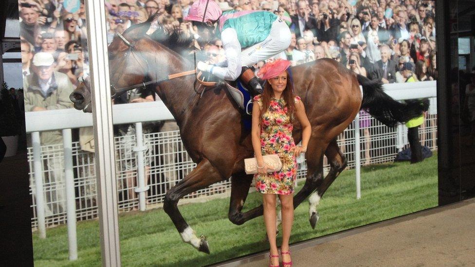 First-time racegoer Hannah King poses in front of a photo of Frankel