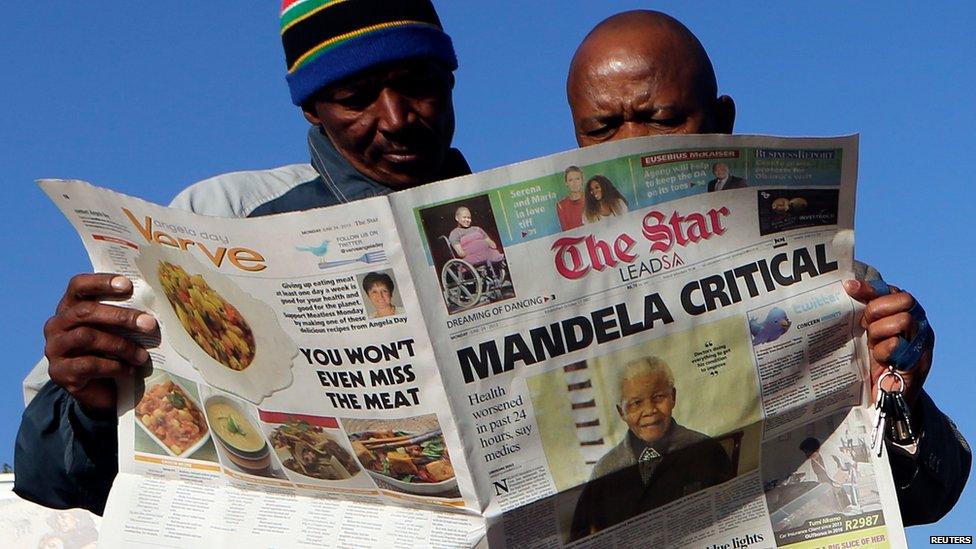 Reading newspapers in Soweto on 24 June 2013