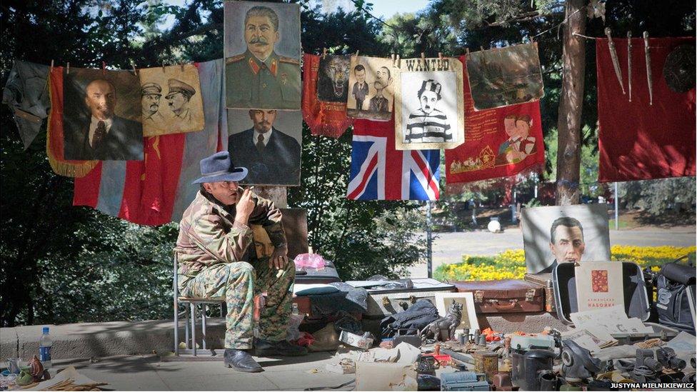 A man sells flags and posters of Soviet leaders at Tbilisi's flea market.